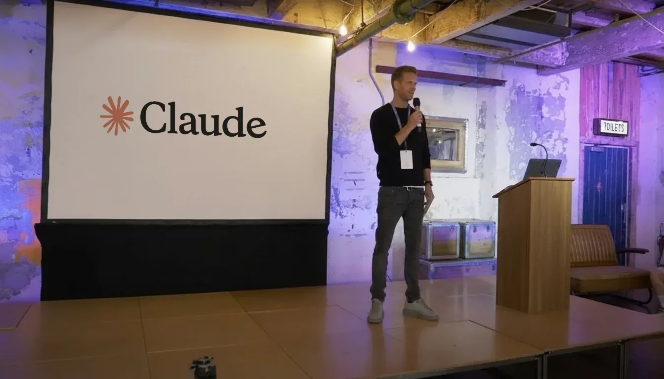 Mark Byrne on stage presenting Claude