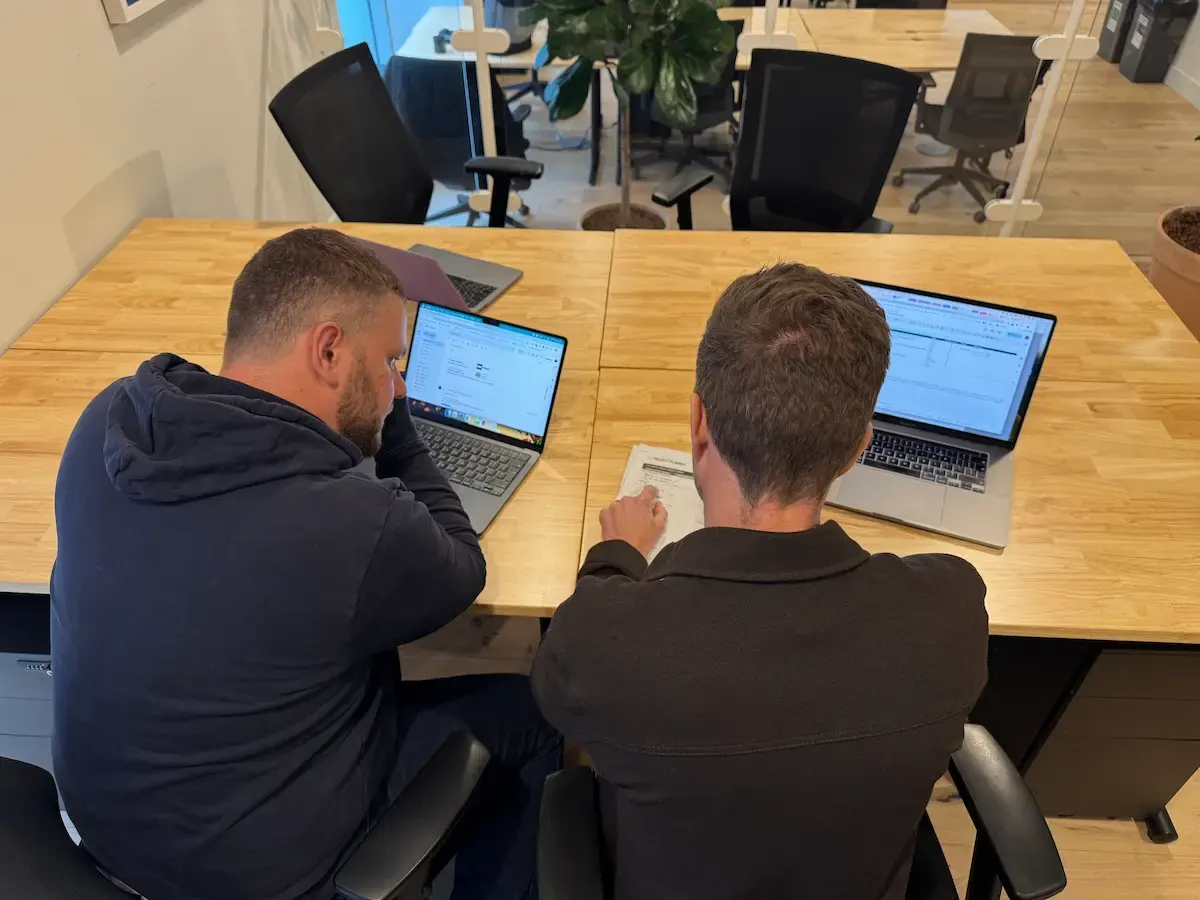 Rikki and Mark working across two laptops