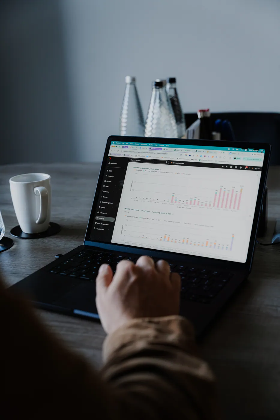 Hands on a laptop showing a report