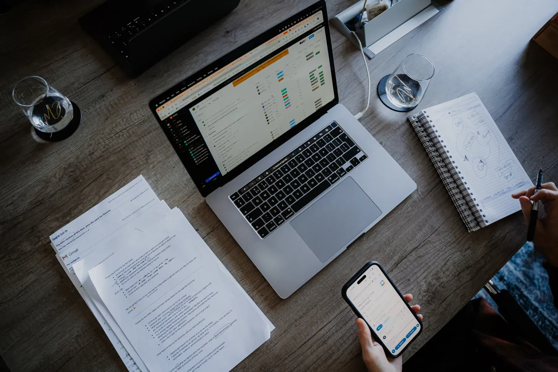 Laptop, phone and notes on the meeting table, from above