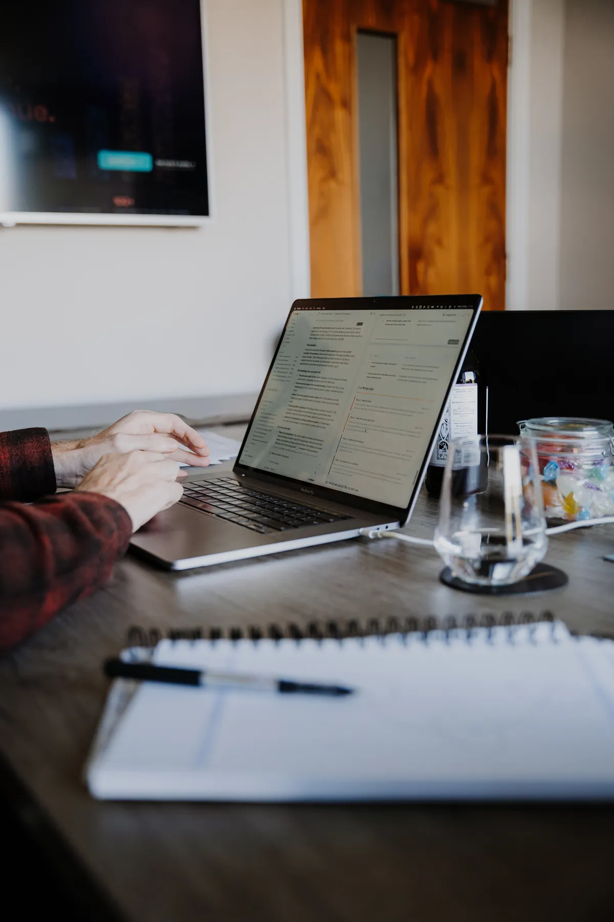 A laptop and notebook on the meeting table